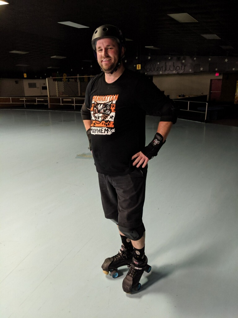 I am posing for a picture during roller derby practice.