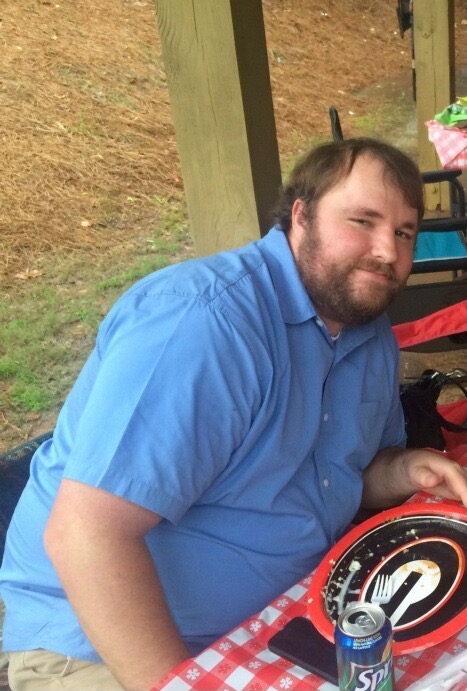 Me sitting on a bench in the park during a birthday party.